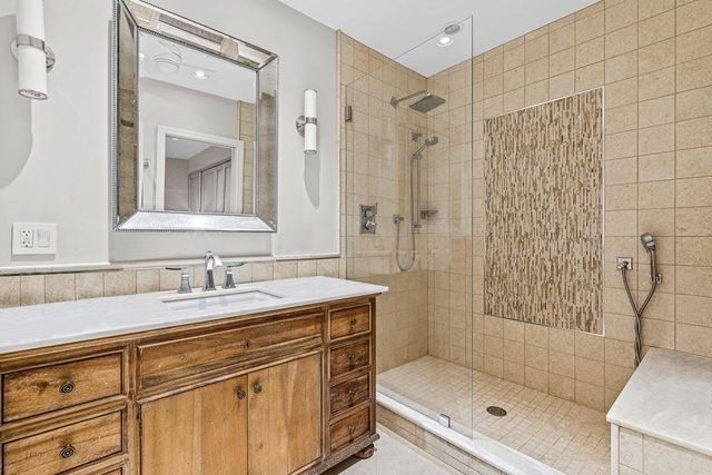 a bathroom with a sink toilet a mirror and shower