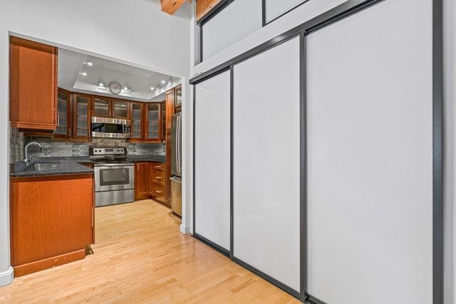 a kitchen with stainless steel appliances granite countertop a refrigerator and a stove top oven
