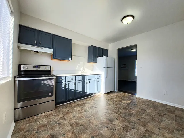 a kitchen with stainless steel appliances a stove and cabinets