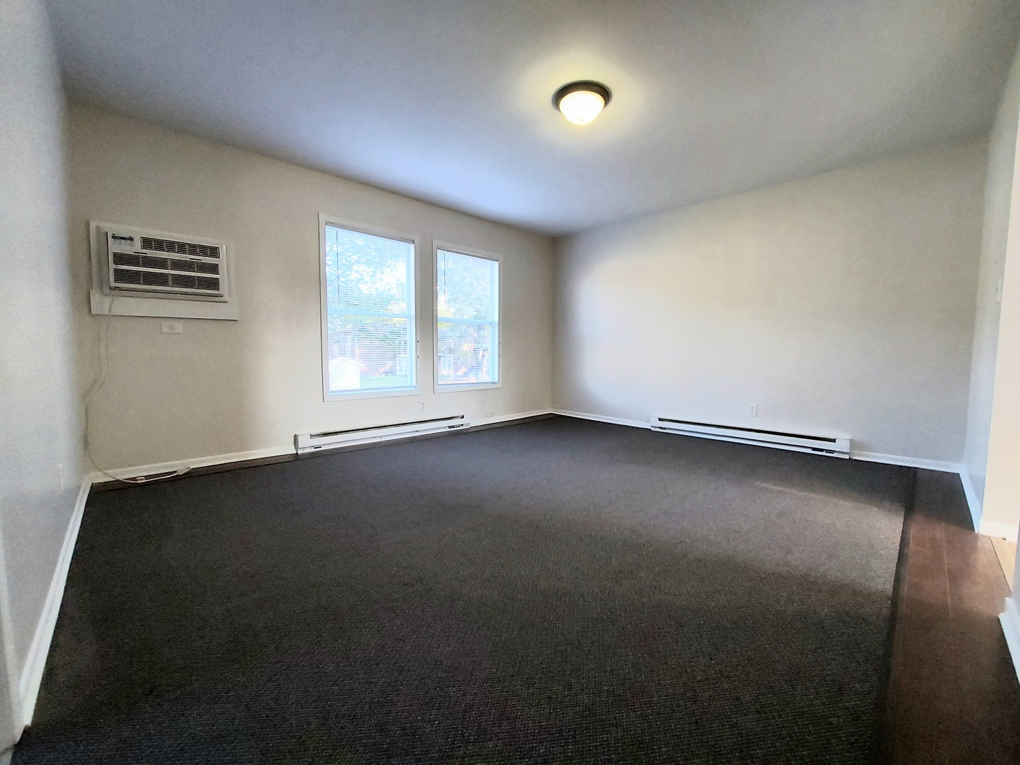 308 Wilshire Drive, Unit 4 Sandwich, IL 60548 - Photo 4 of 9 an empty room with a window