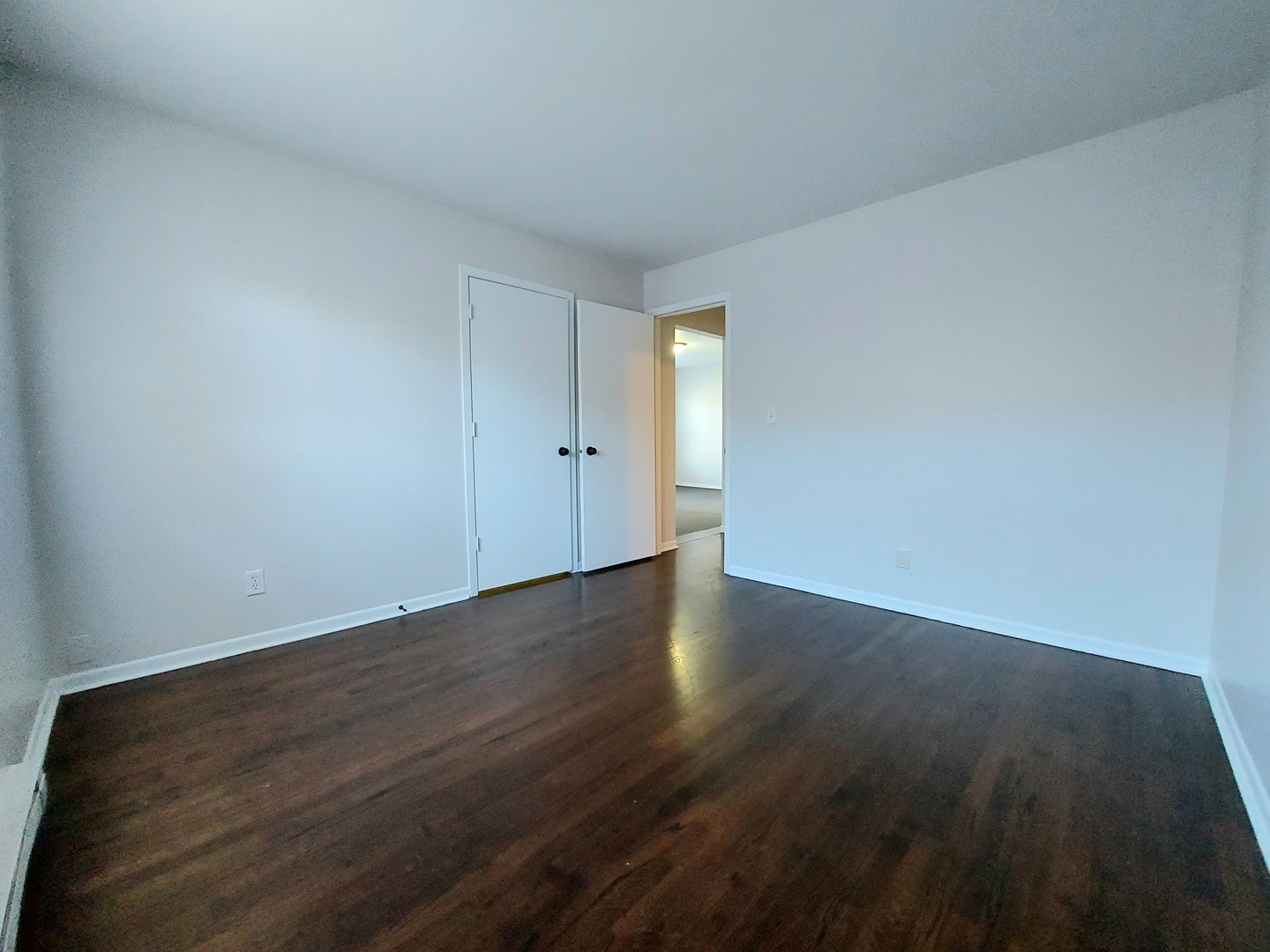 308 Wilshire Drive, Unit 4 Sandwich, IL 60548 - Photo 6 of 9 a view of an empty room and wooden floor