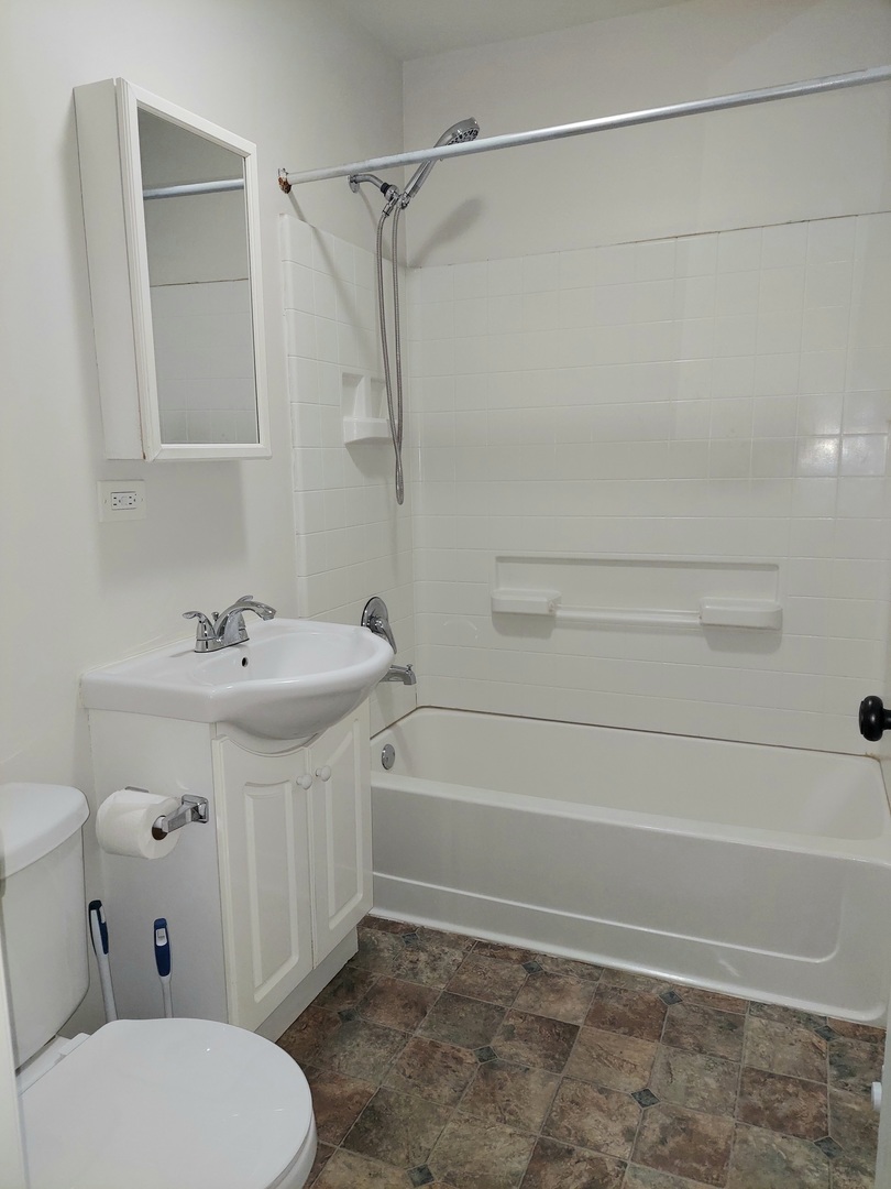 308 Wilshire Drive, Unit 4 Sandwich, IL 60548 - Photo 9 of 9 a bathroom with a sink a toilet and shower