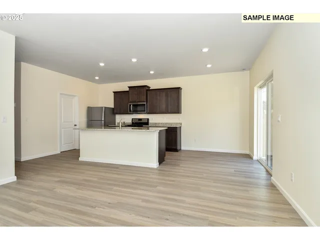 a view of kitchen view wooden cabinets and window