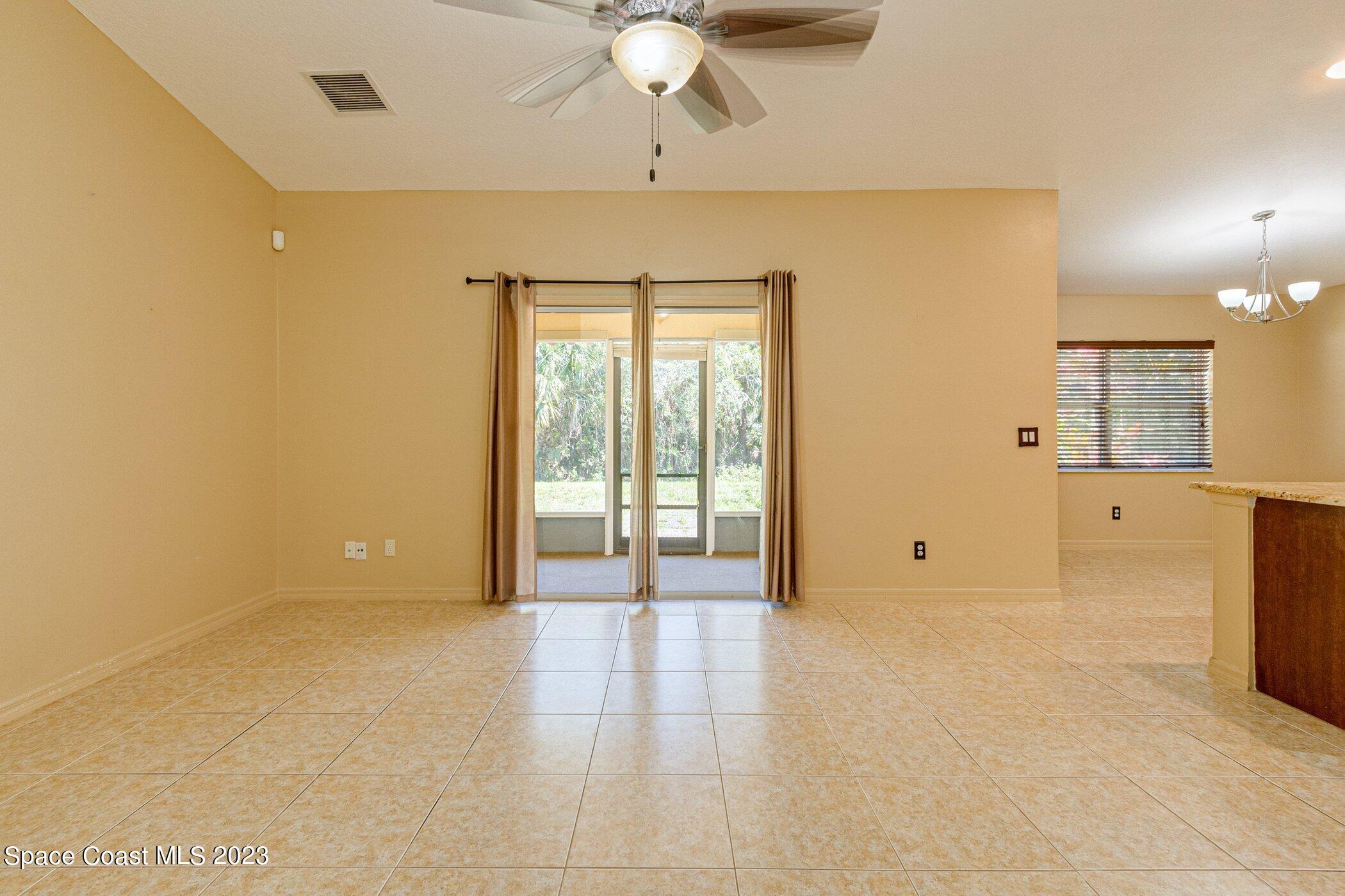 1371 Darrow Road Southwest Palm Bay, FL 32908 - Photo 11 of 21 a view of an empty room with a window