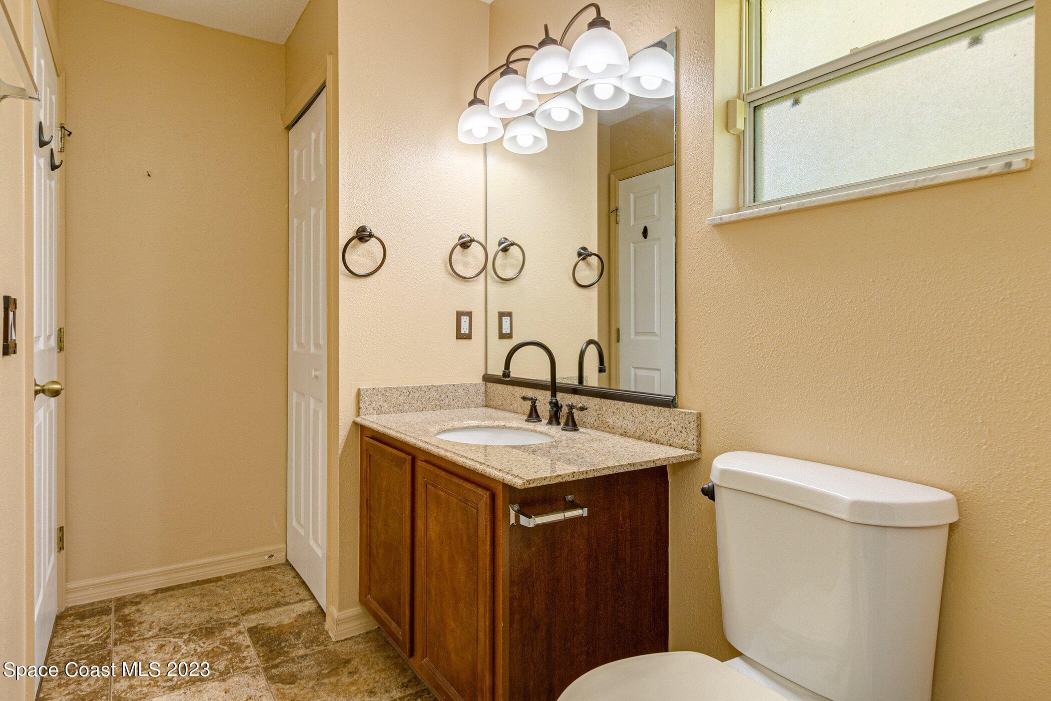 1371 Darrow Road Southwest Palm Bay, FL 32908 - Photo 14 of 21 a bathroom with a sink a toilet and shower