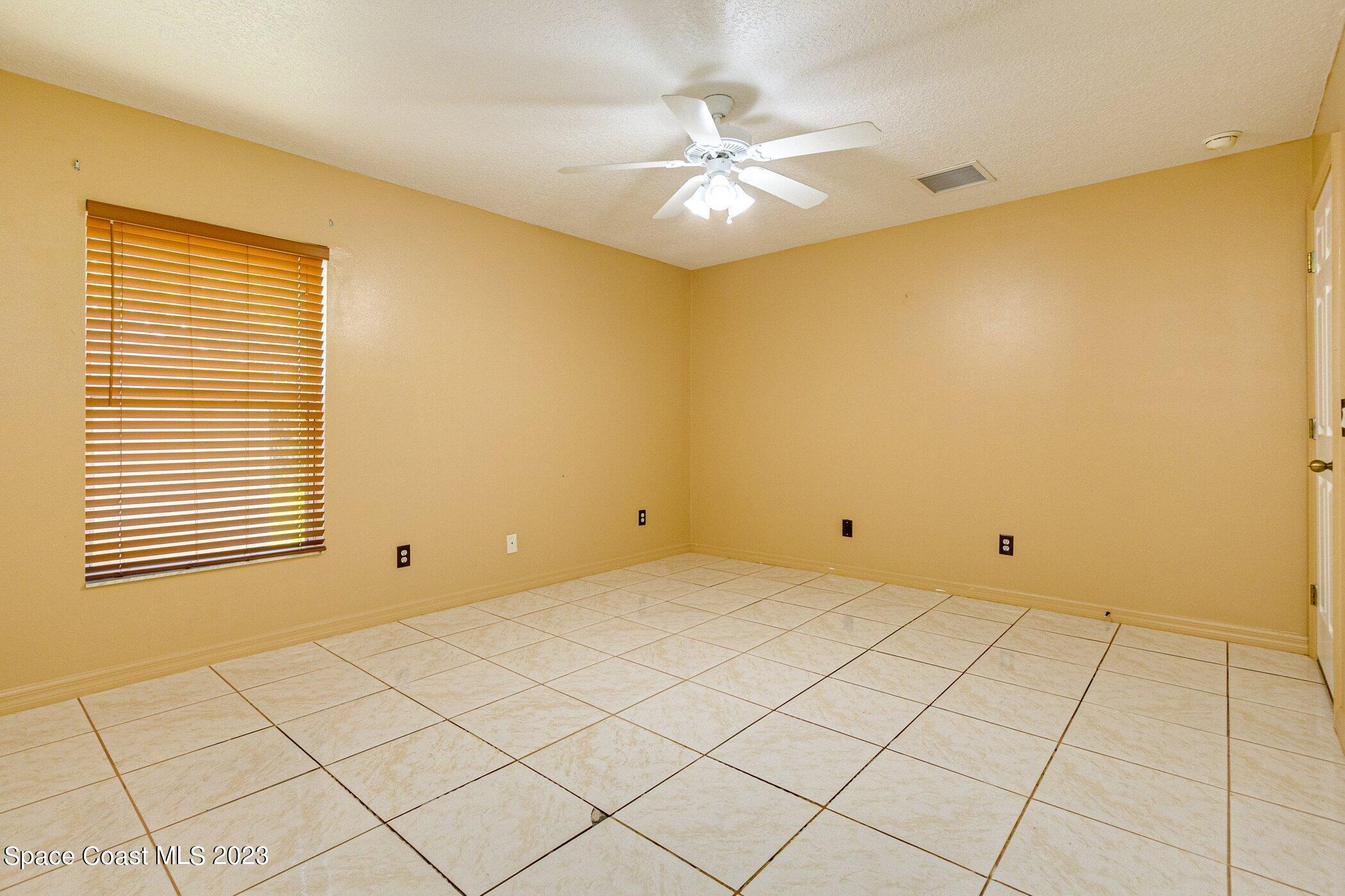1371 Darrow Road Southwest Palm Bay, FL 32908 - Photo 15 of 21 a view of an empty room with a window