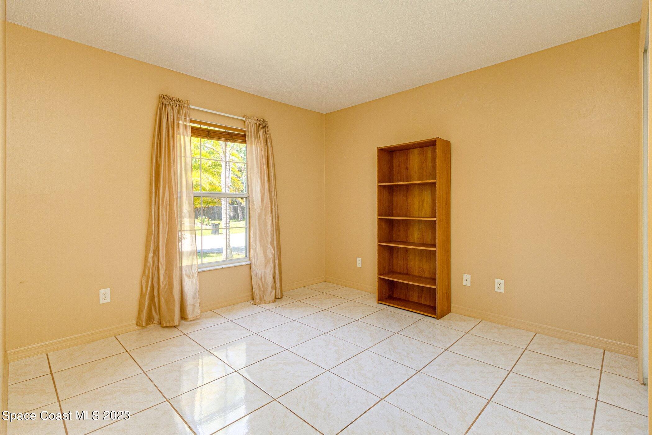 1371 Darrow Road Southwest Palm Bay, FL 32908 - Photo 16 of 21 a view of an empty room and window