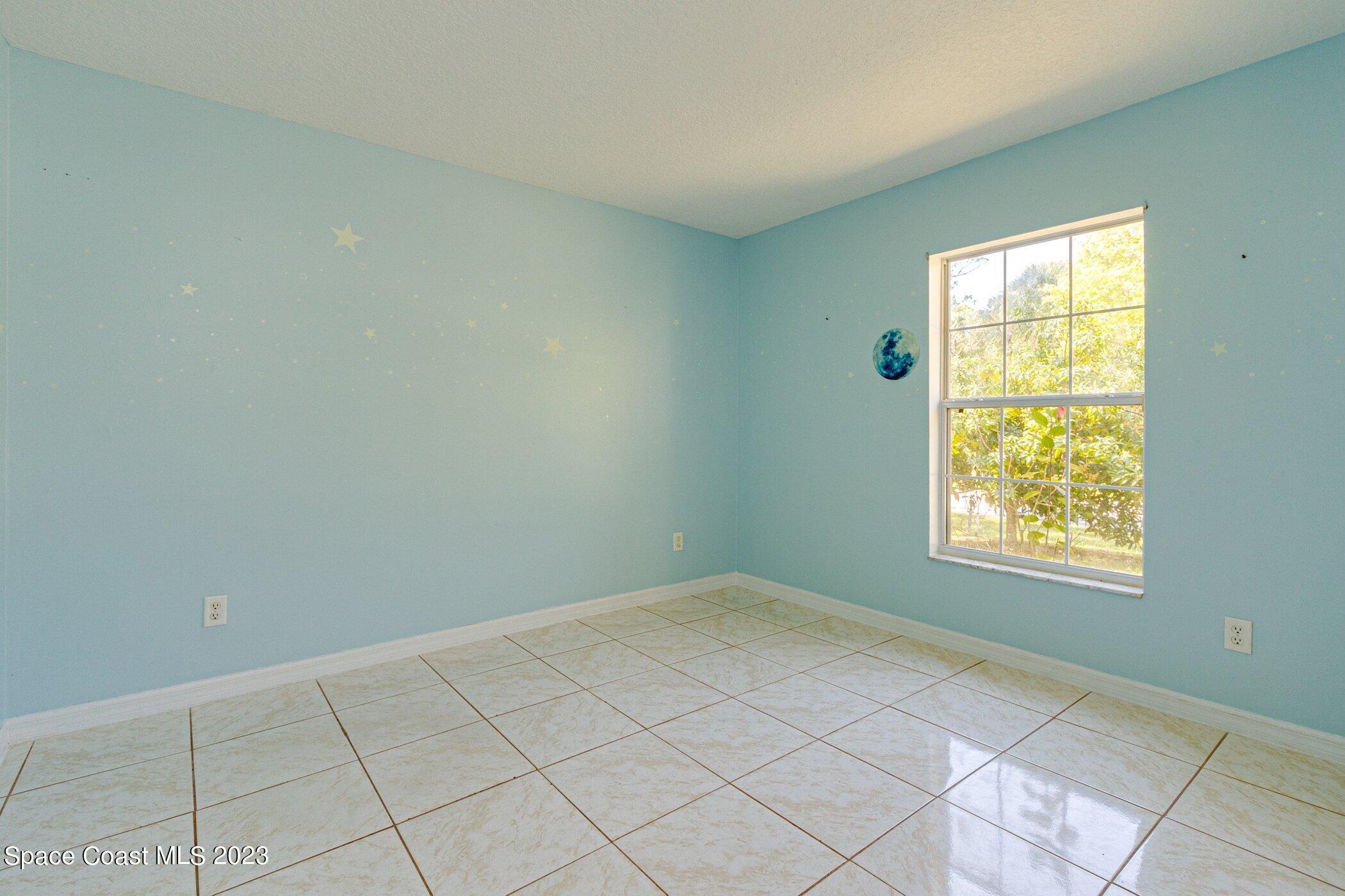 1371 Darrow Road Southwest Palm Bay, FL 32908 - Photo 19 of 21 a view of an empty room and window