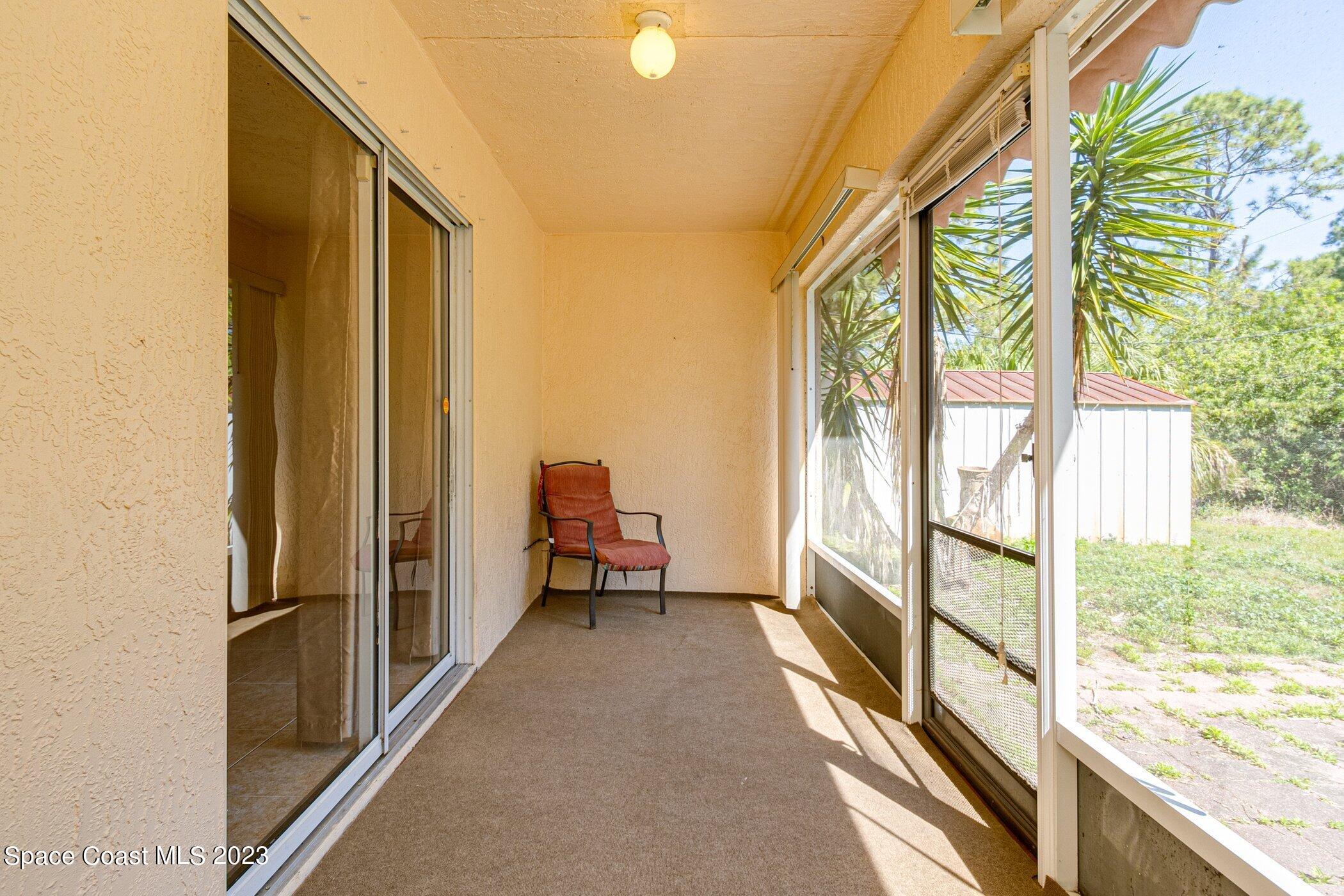 1371 Darrow Road Southwest Palm Bay, FL 32908 - Photo 20 of 21 a view of a balcony with wooden floor and furniture