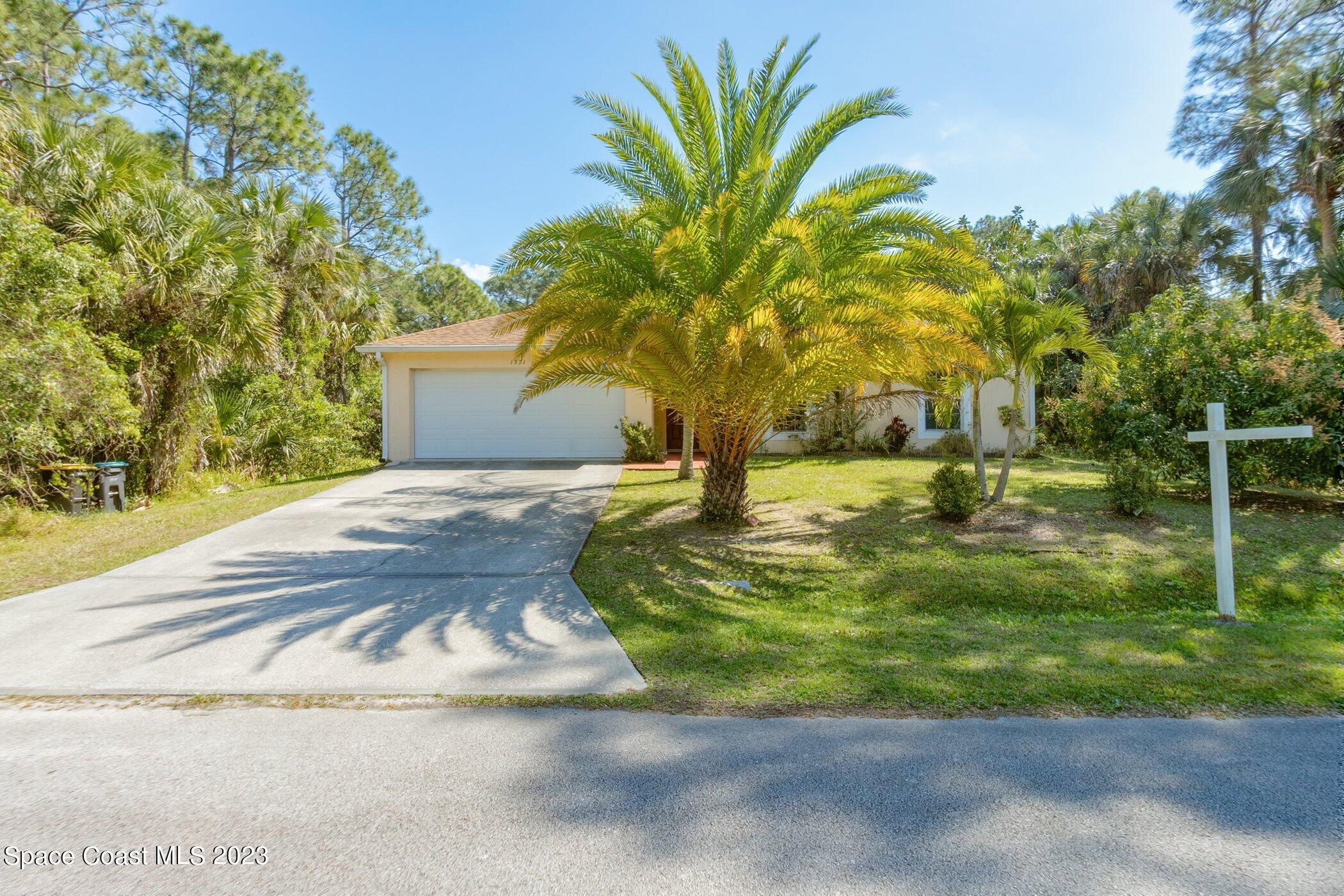 1371 Darrow Road Southwest Palm Bay, FL 32908 - Photo 2 of 21 a view of a yard with palm trees