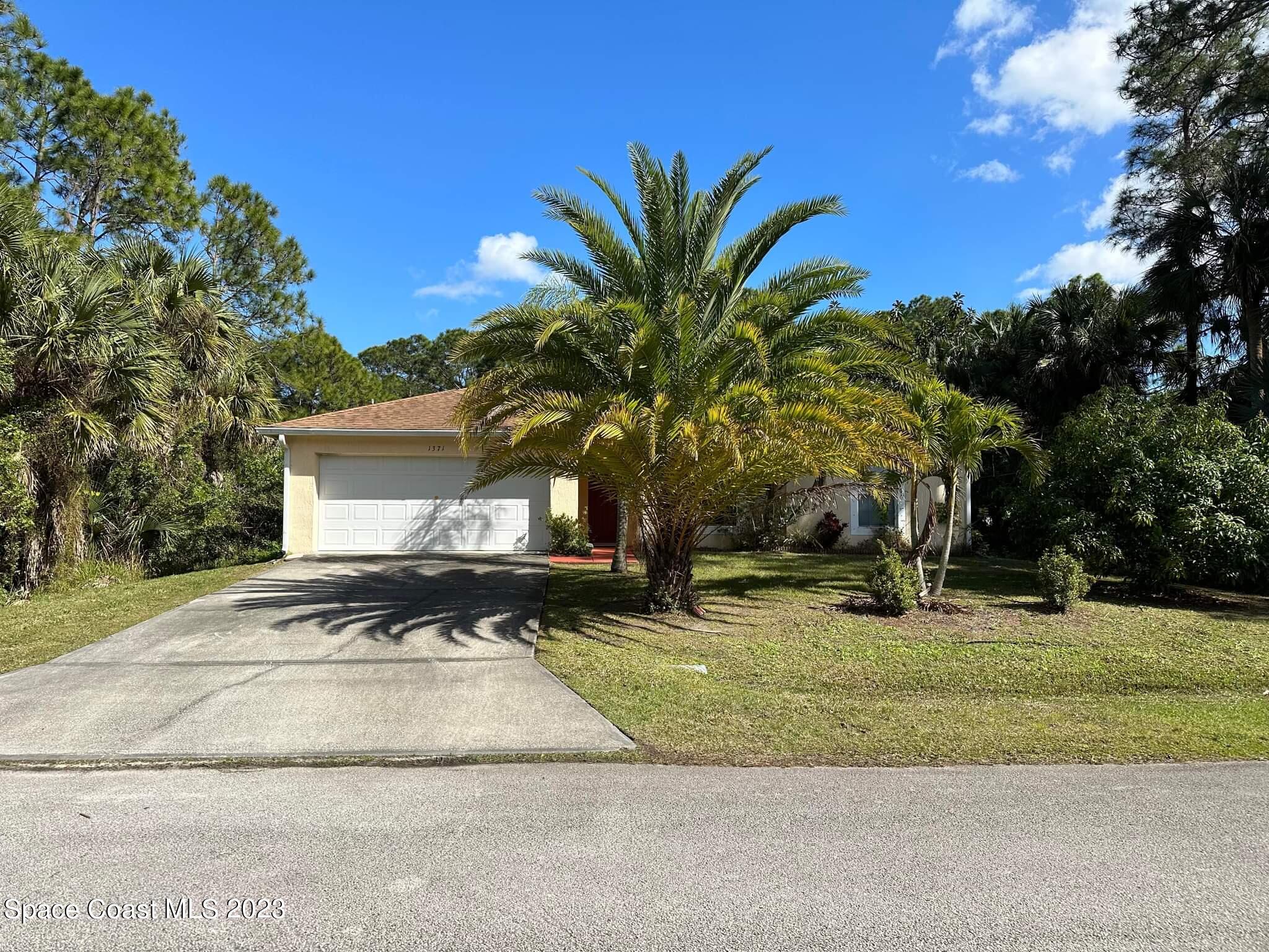 1371 Darrow Road Southwest Palm Bay, FL 32908 - Photo 21 of 21 a view of a house with a yard