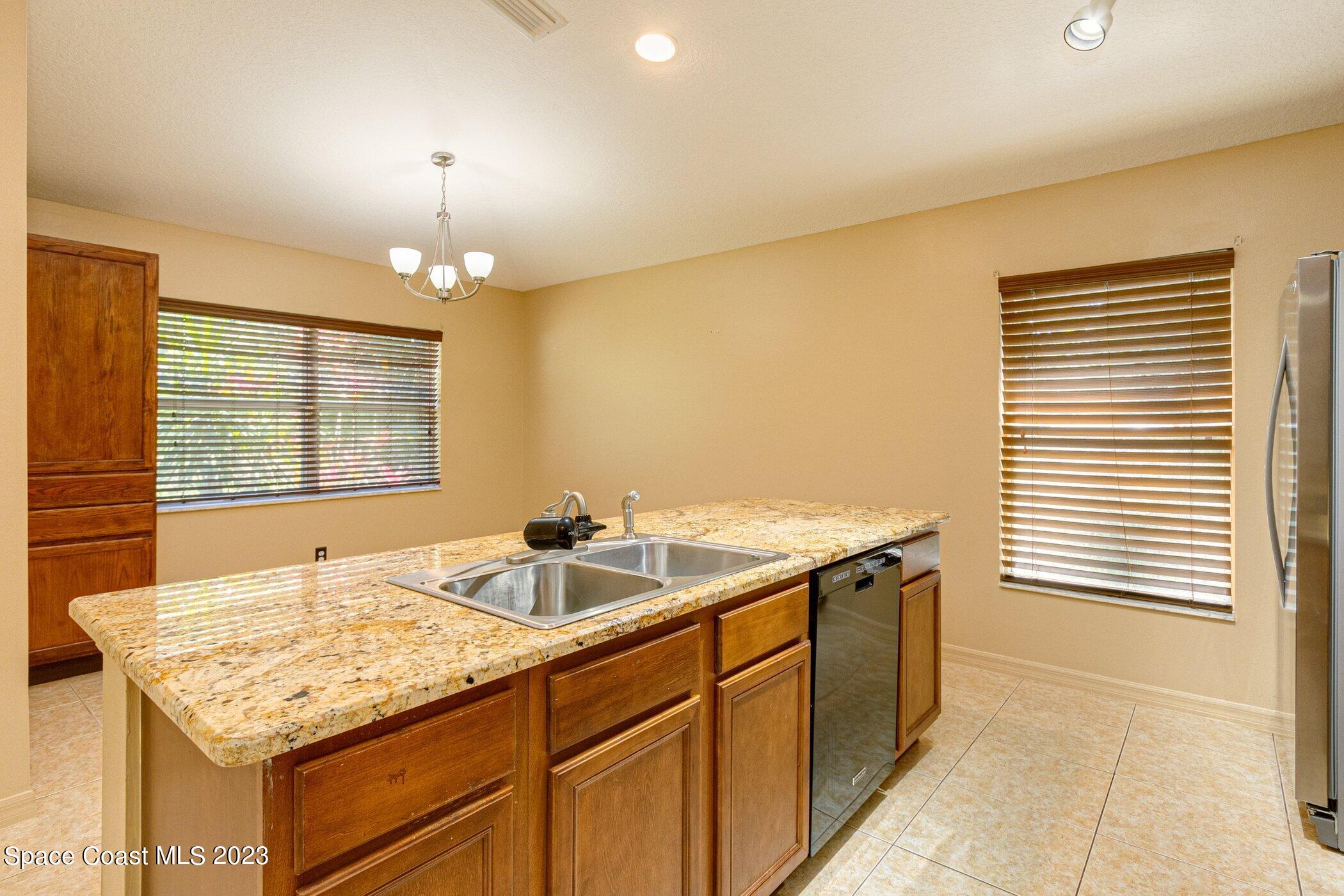 1371 Darrow Road Southwest Palm Bay, FL 32908 - Photo 7 of 21 a kitchen with a sink and a window