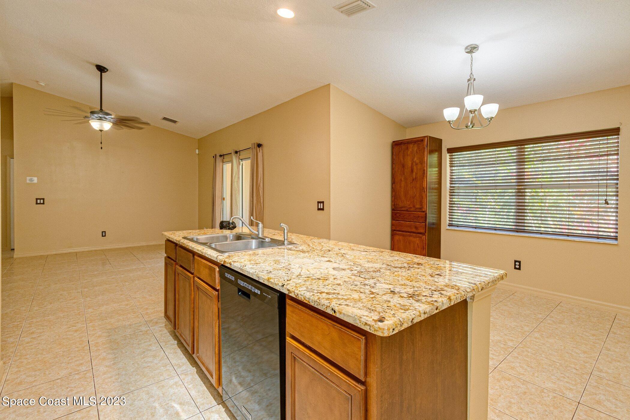 1371 Darrow Road Southwest Palm Bay, FL 32908 - Photo 8 of 21 a bathroom with a granite countertop sink and a mirror