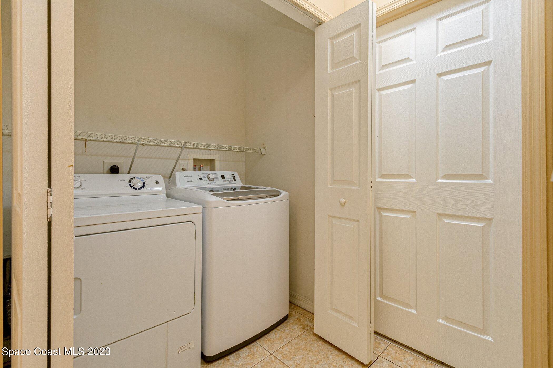 1371 Darrow Road Southwest Palm Bay, FL 32908 - Photo 9 of 21 a utility room with dryer and washer