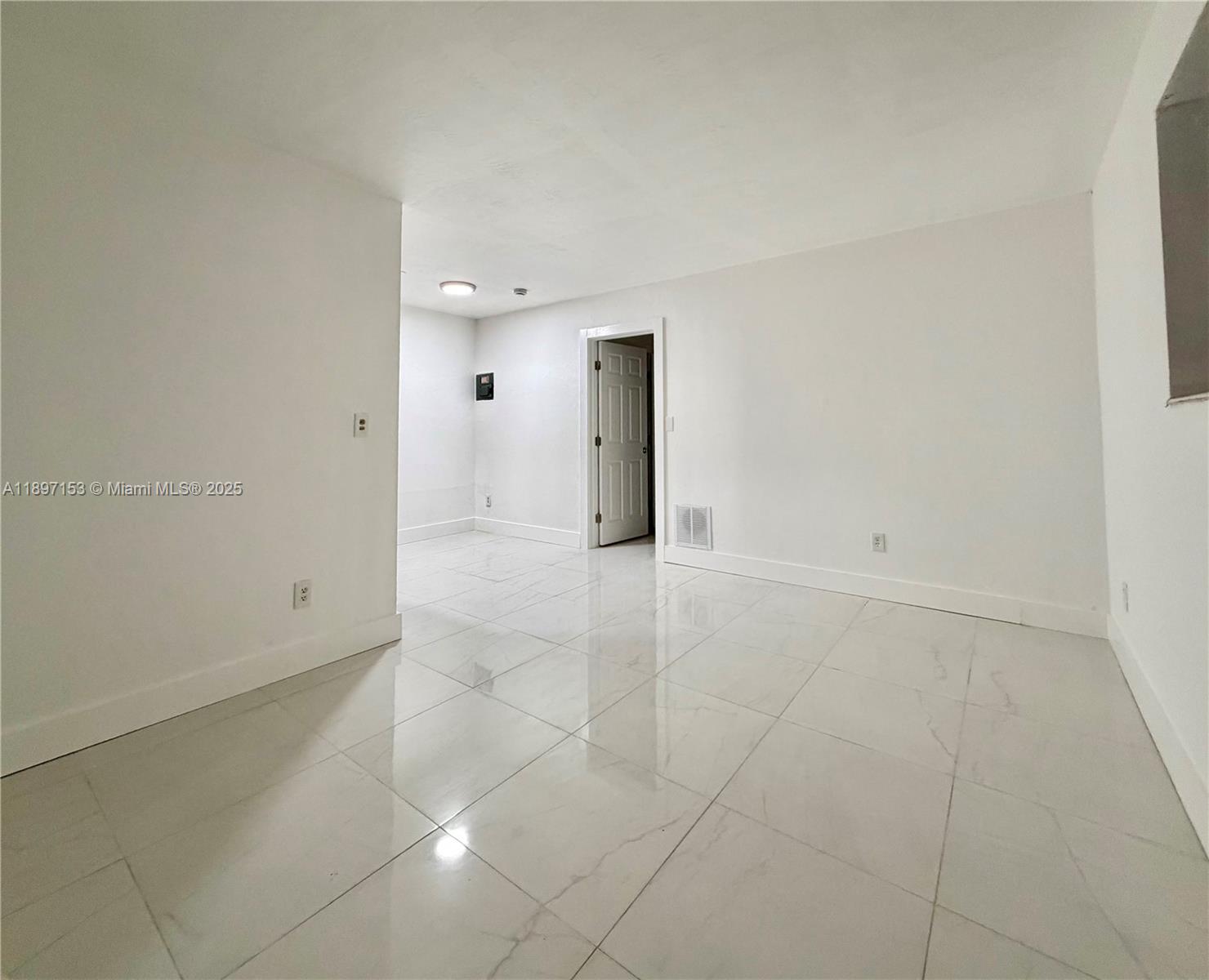 3100 Northwest 135th Street, Unit 4 Opa-Locka, FL 33054 - Photo 1 of 5 an empty room with glass door