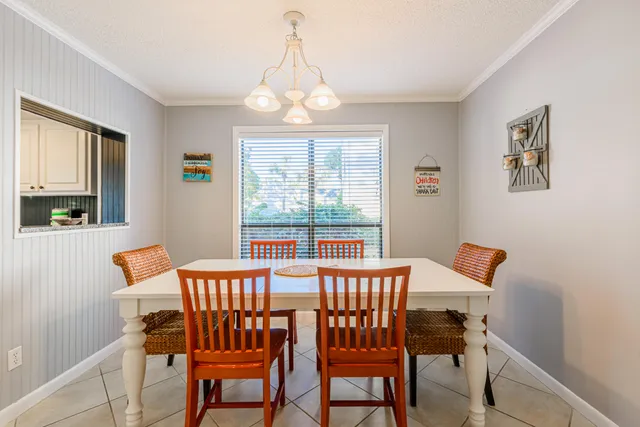 a dining room with a wooden table and chairs