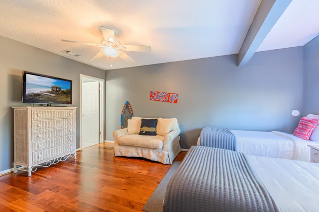 a bedroom with furniture and a flat screen tv