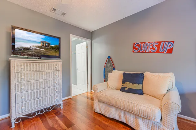 a bedroom with furniture and wooden floor