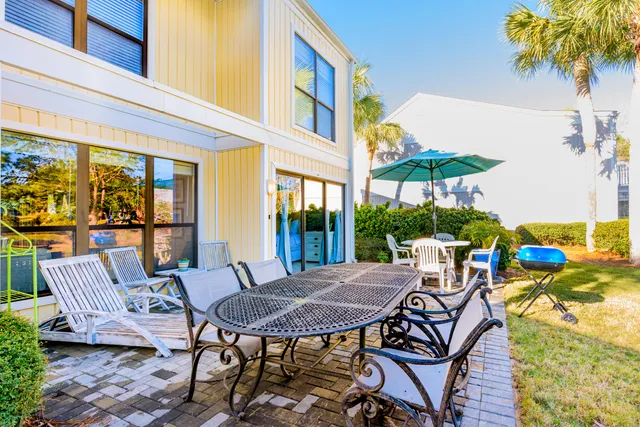 a view of a patio with table and chairs under an umbrella