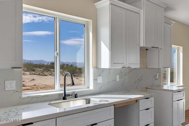 a kitchen with a sink cabinets and window