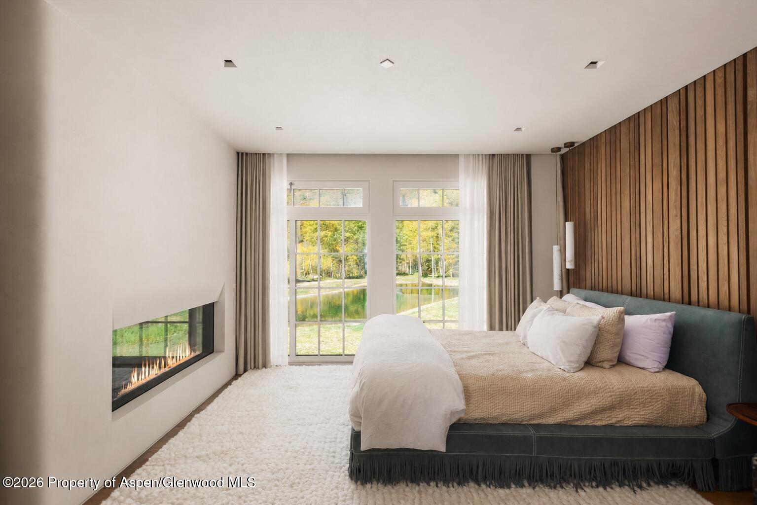 5387 Castle Creek Road Aspen, CO 81612 - Photo 11 of 25 a large white bed sitting in a room next to a window