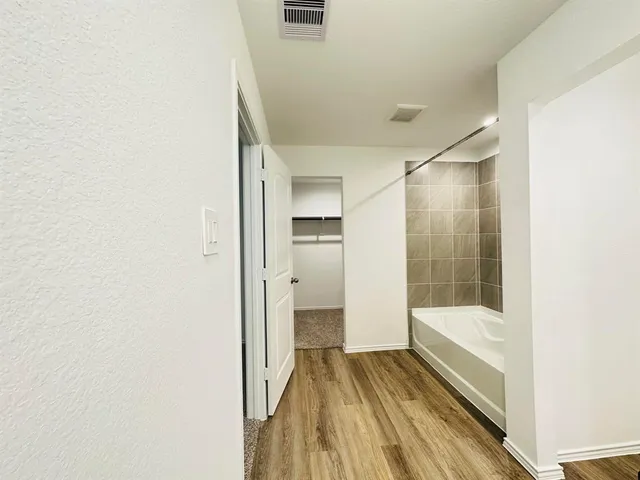 a bathroom with a bathtub and a shower