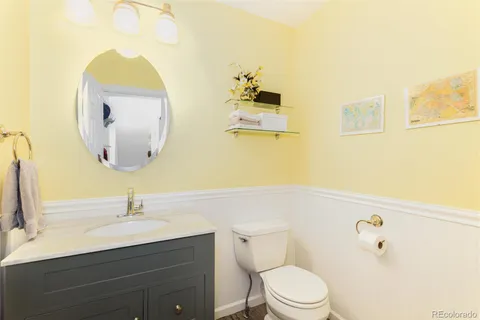a bathroom with a sink mirror and toilet