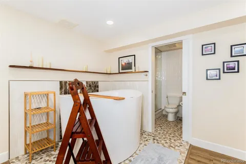 a bathroom with a sink vanity mirror and toilet