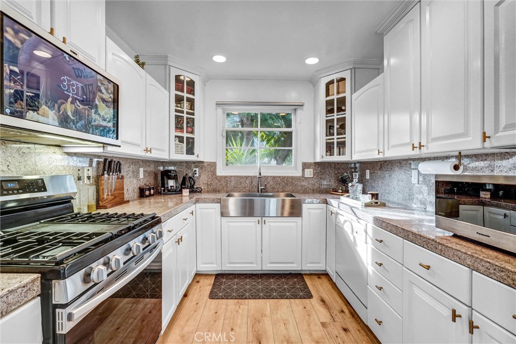 7758 Chimineas Avenue Reseda, CA 91335 - Photo 12 of 35 a kitchen with stainless steel appliances granite countertop a stove and a sink