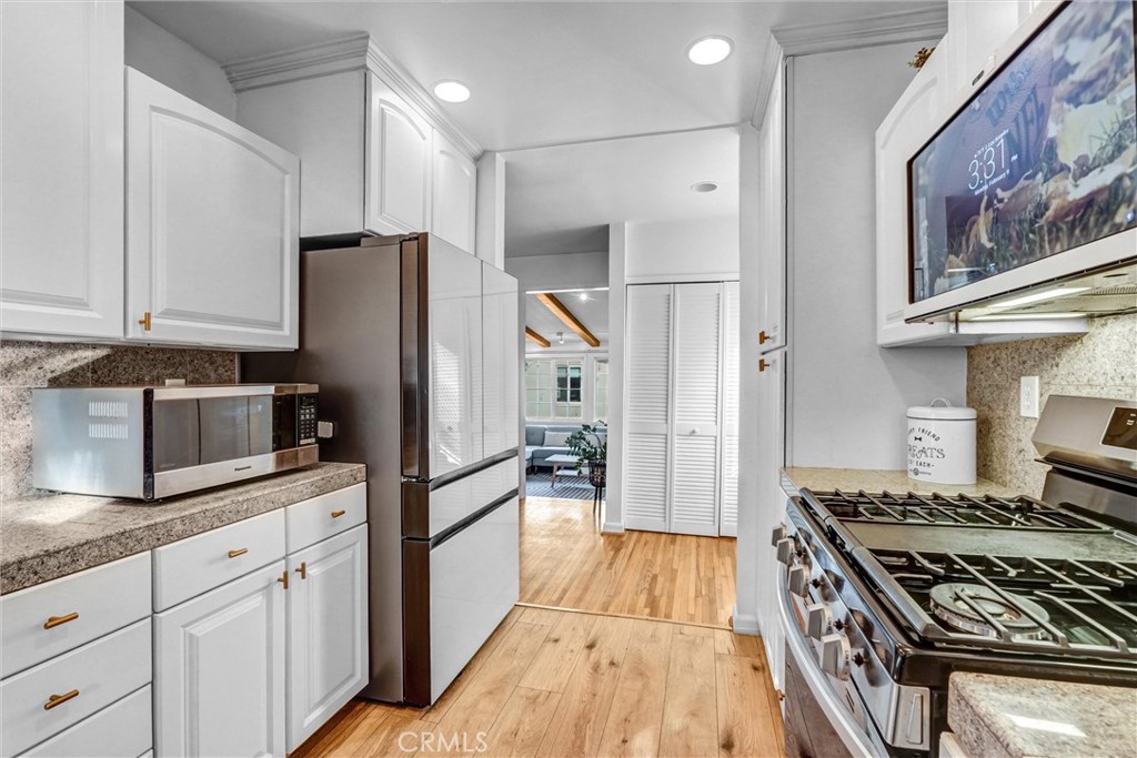 7758 Chimineas Avenue Reseda, CA 91335 - Photo 13 of 35 a kitchen with stainless steel appliances granite countertop a refrigerator stove and sink