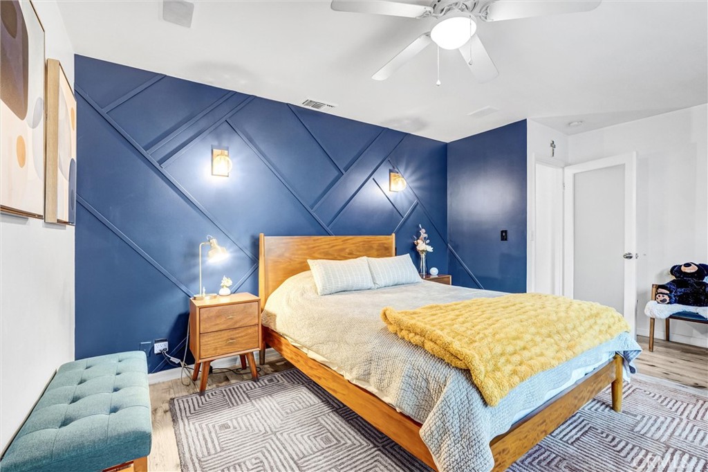 7758 Chimineas Avenue Reseda, CA 91335 - Photo 17 of 35 a bedroom with a bed and a chandelier