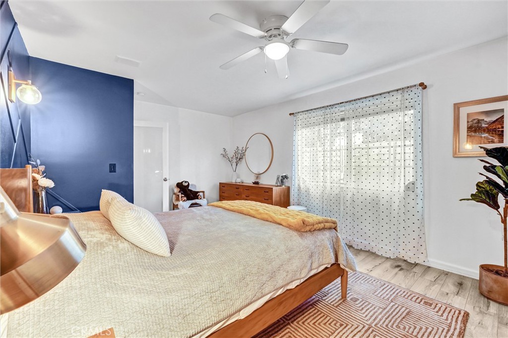 7758 Chimineas Avenue Reseda, CA 91335 - Photo 18 of 35 a bedroom with a bed and a chandelier