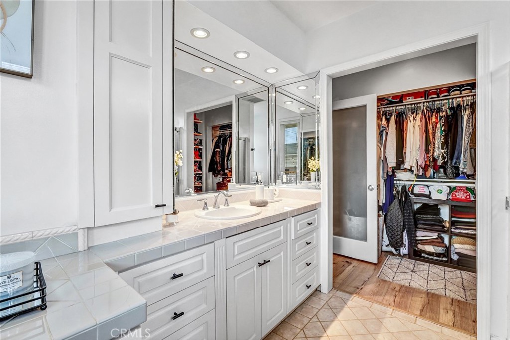 7758 Chimineas Avenue Reseda, CA 91335 - Photo 20 of 35 a spacious bathroom with a granite countertop sink and a mirror