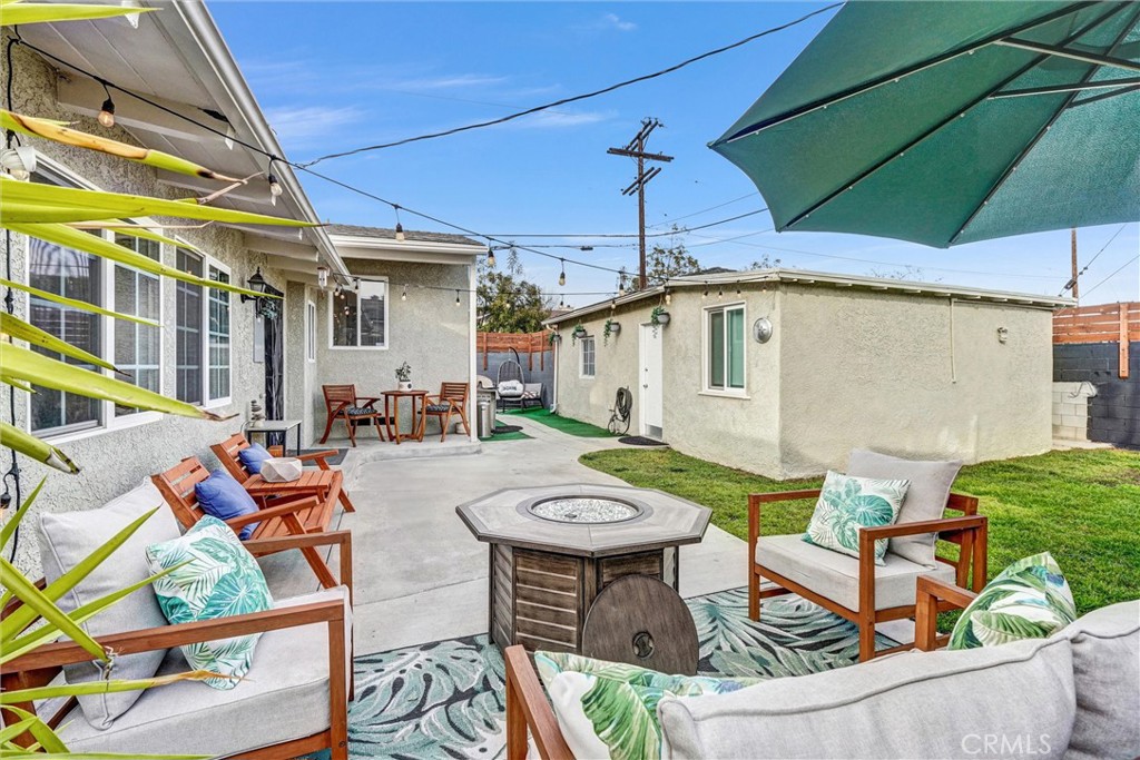 7758 Chimineas Avenue Reseda, CA 91335 - Photo 21 of 35 a view of a patio with table and chairs under an umbrella