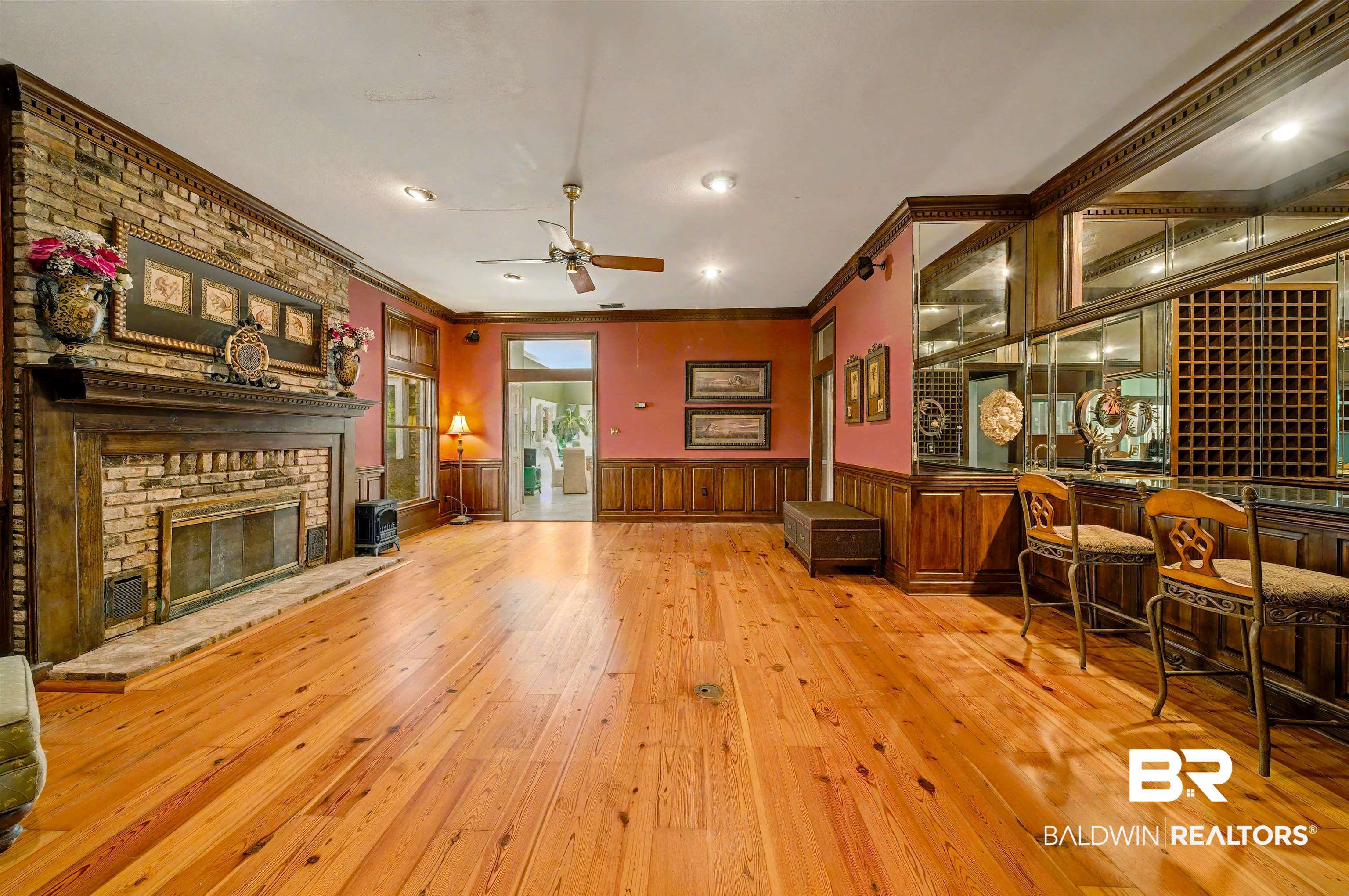 15810 County Road 73 Foley, AL 36535 - Photo 44 of 56 Living area with wainscoting, crown molding, light wood-type flooring, a fireplace, and a ceiling fan