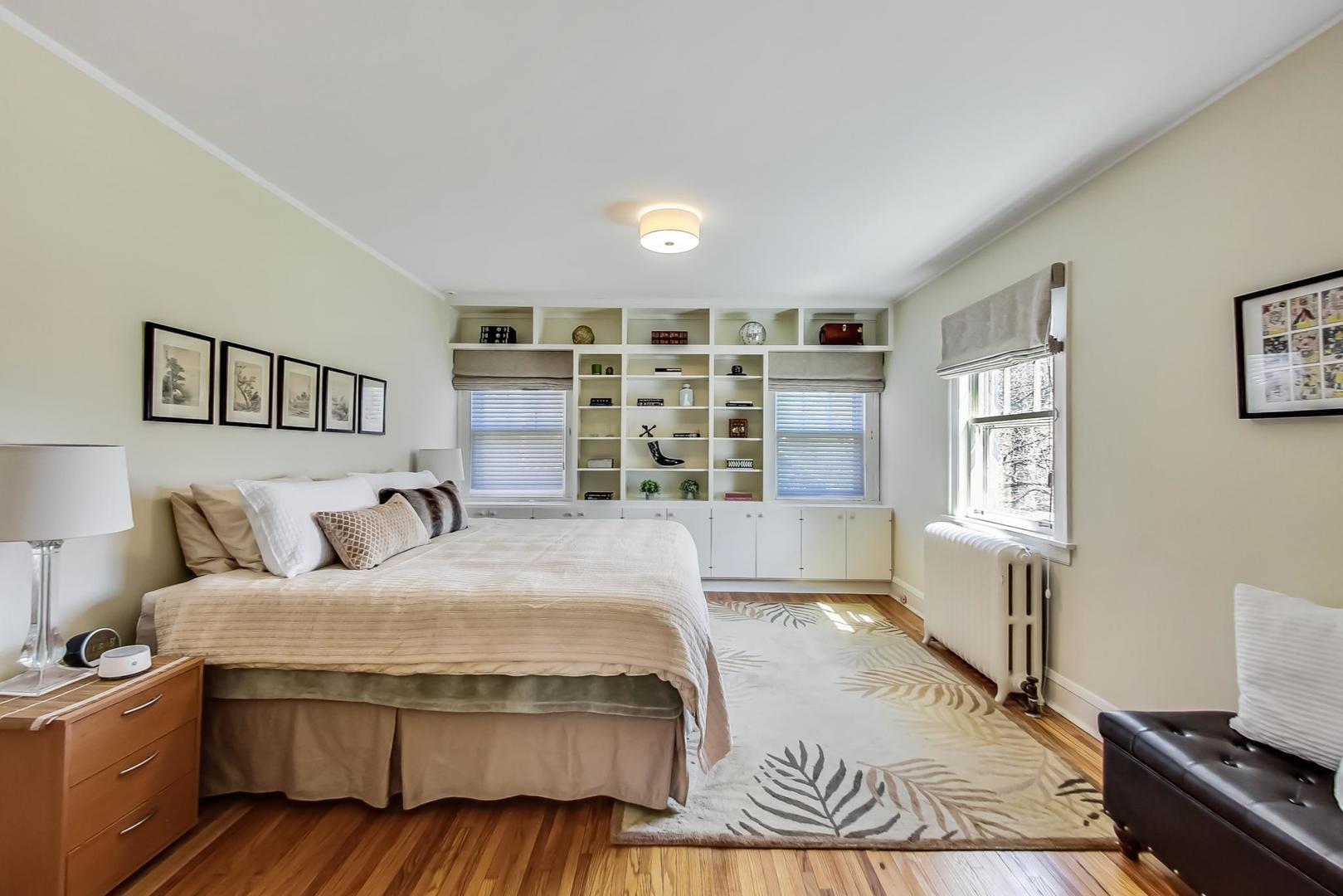 216 Myrtle Street Winnetka, IL 60093 - Photo 29 of 74 a spacious bedroom with a large bed and a window