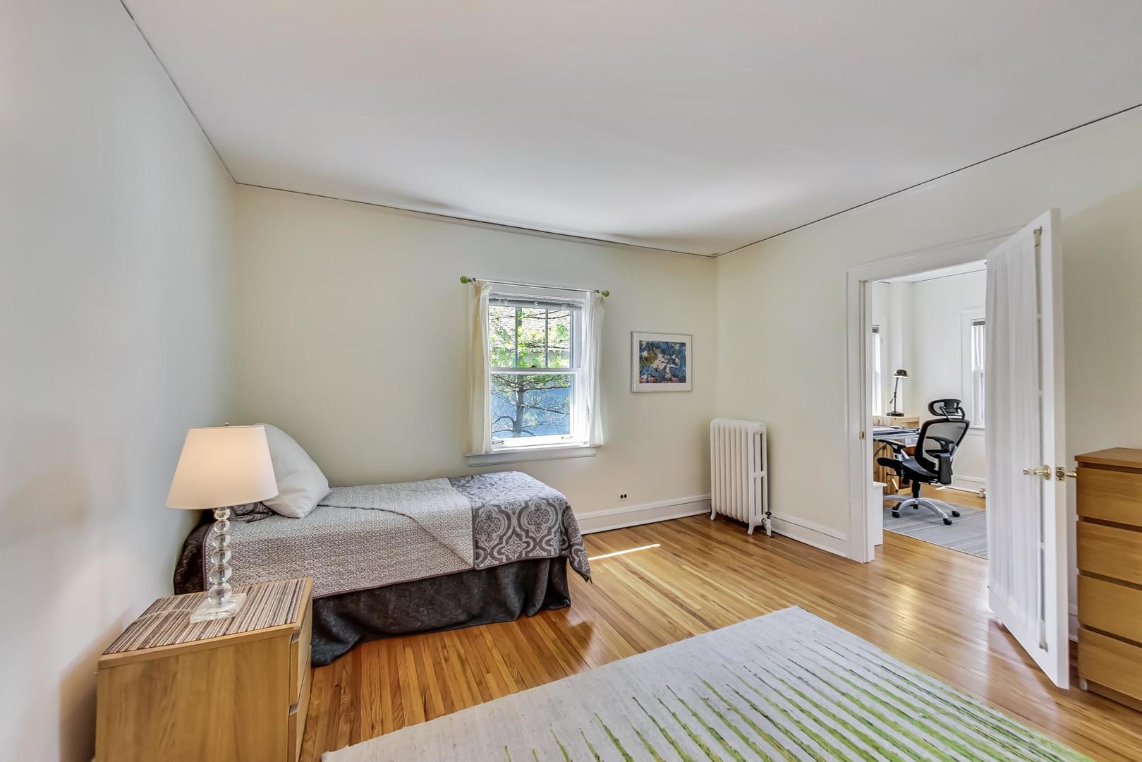 216 Myrtle Street Winnetka, IL 60093 - Photo 36 of 74 a bedroom with a bed and wooden floor