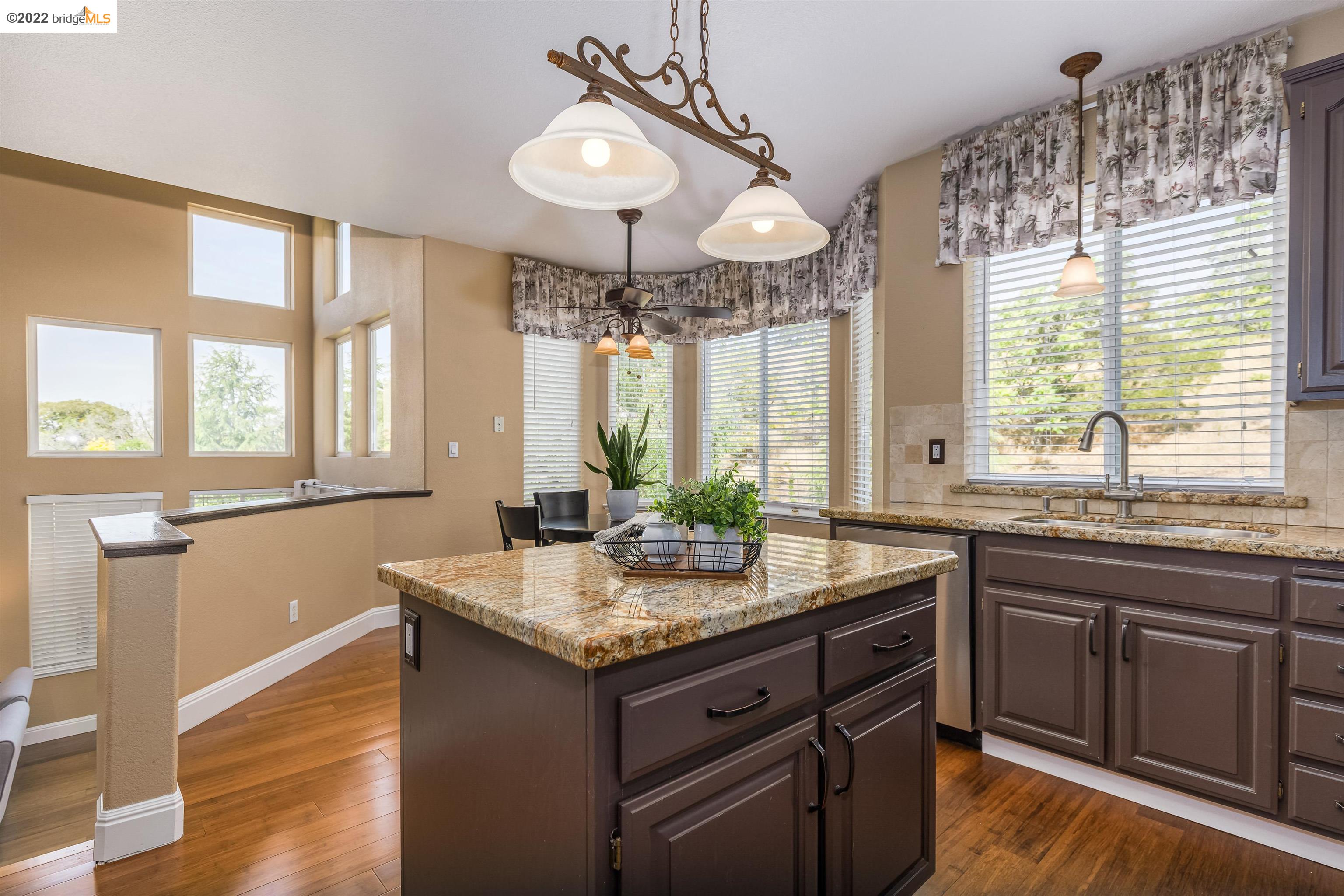 Undisclosed Address Concord, CA 94521 - Photo 12 of 47 a kitchen with granite countertop a sink and dishwasher with wooden floor