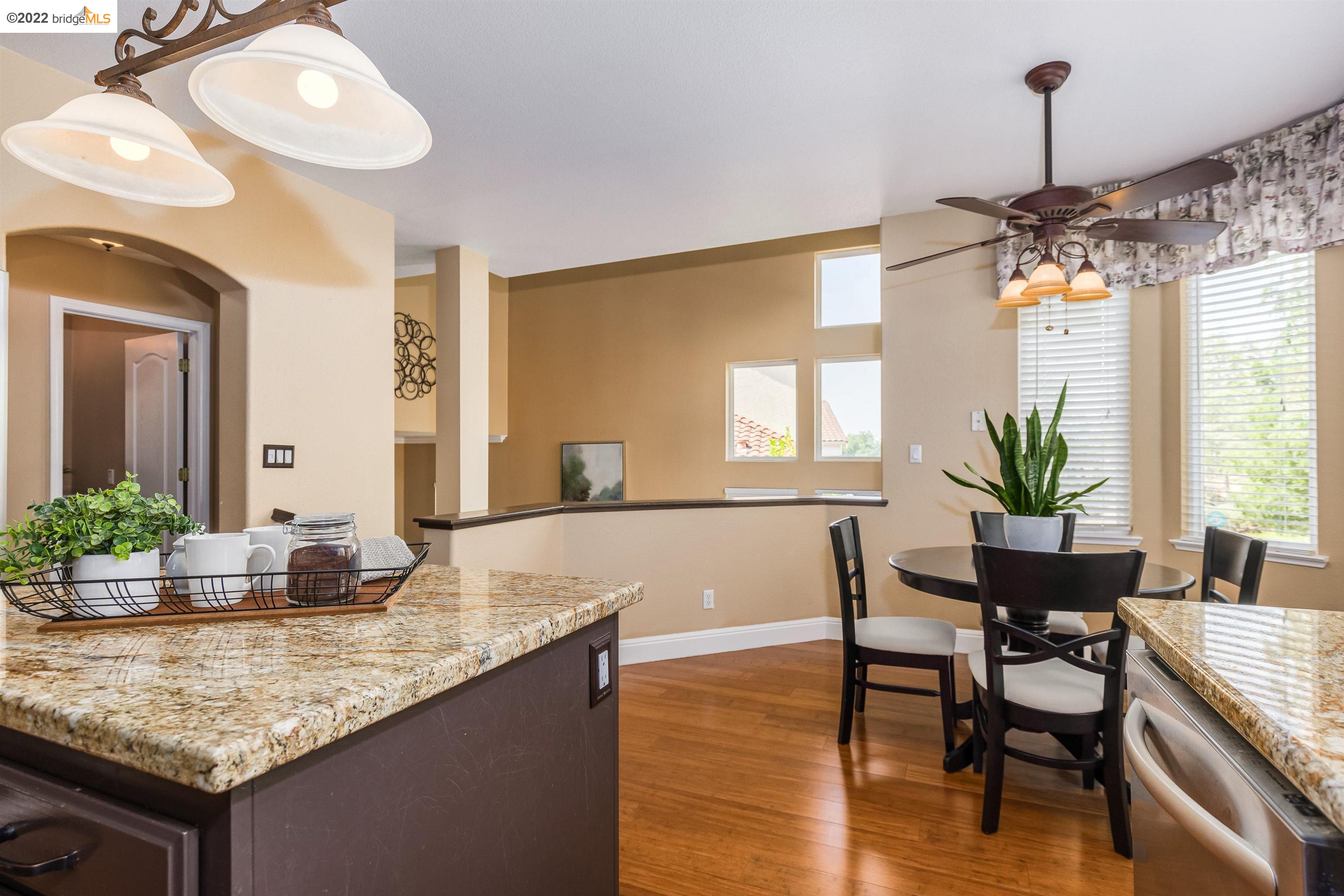Undisclosed Address Concord, CA 94521 - Photo 13 of 47 a dining room with granite countertop wooden floor and a chandelier