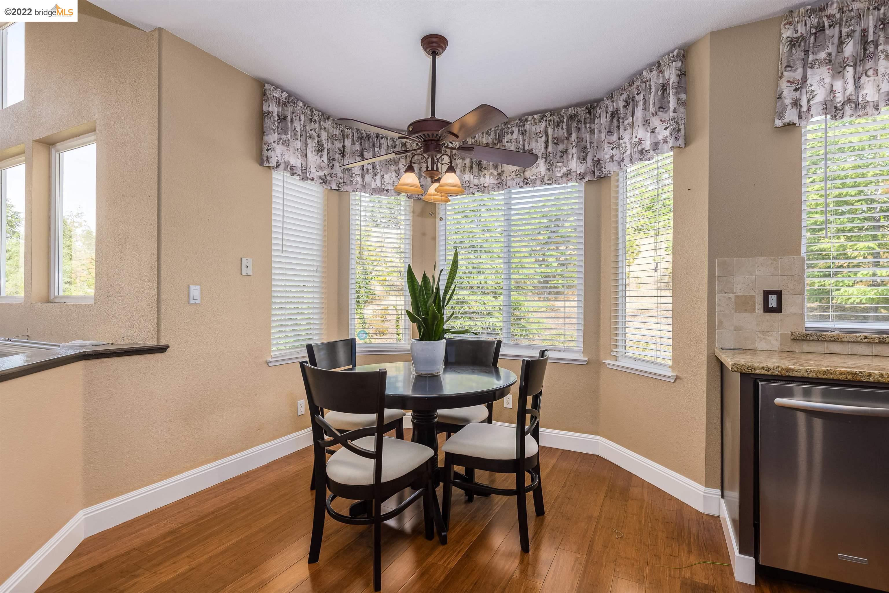 Undisclosed Address Concord, CA 94521 - Photo 14 of 47 a dining room with wooden floor a chandelier a wooden table and chairs