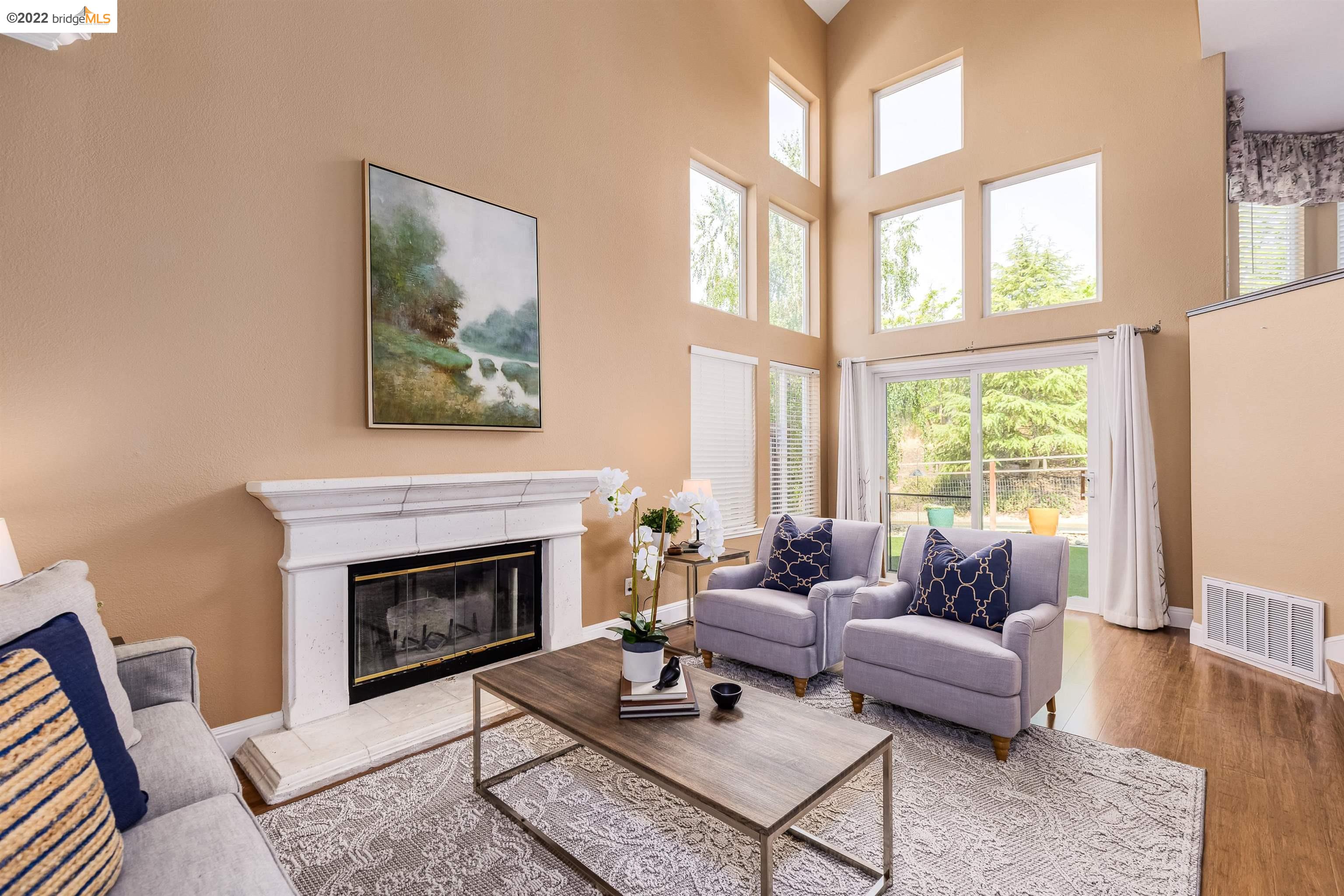 Undisclosed Address Concord, CA 94521 - Photo 17 of 47 a living room with furniture a rug a fireplace and a large window