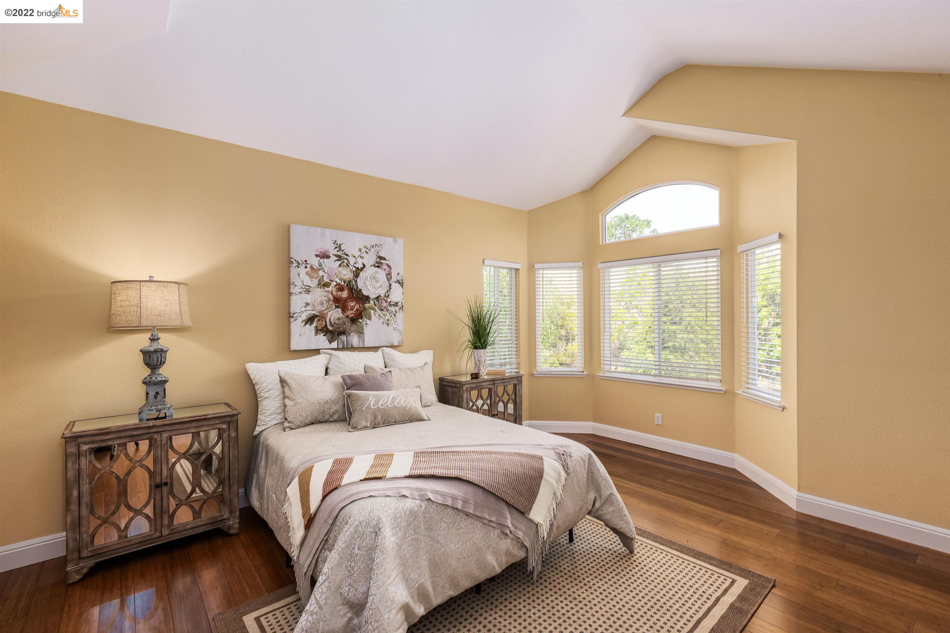 Undisclosed Address Concord, CA 94521 - Photo 22 of 47 a bedroom with a bed and wooden floor