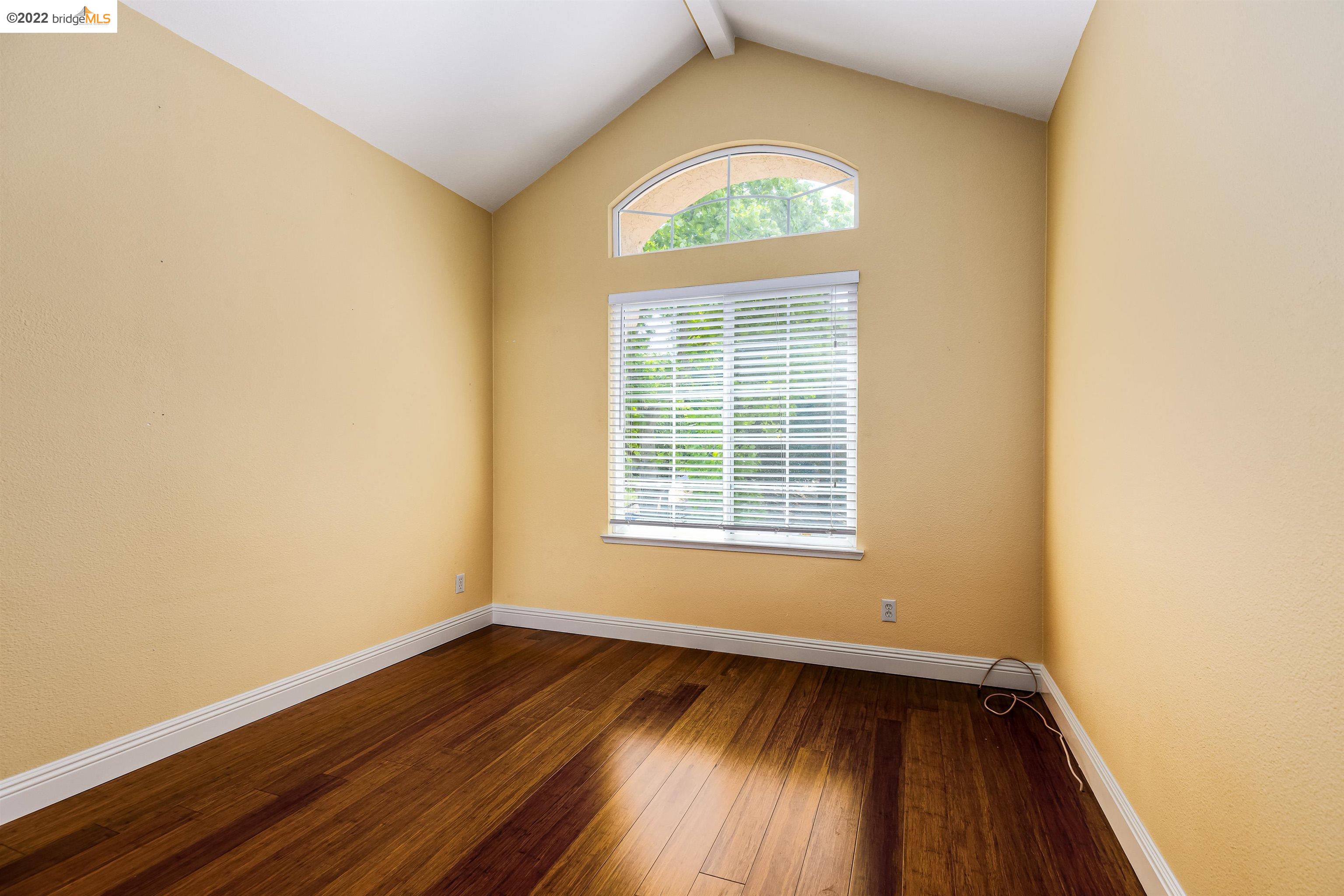 Undisclosed Address Concord, CA 94521 - Photo 28 of 47 an empty room with wooden floor and a window