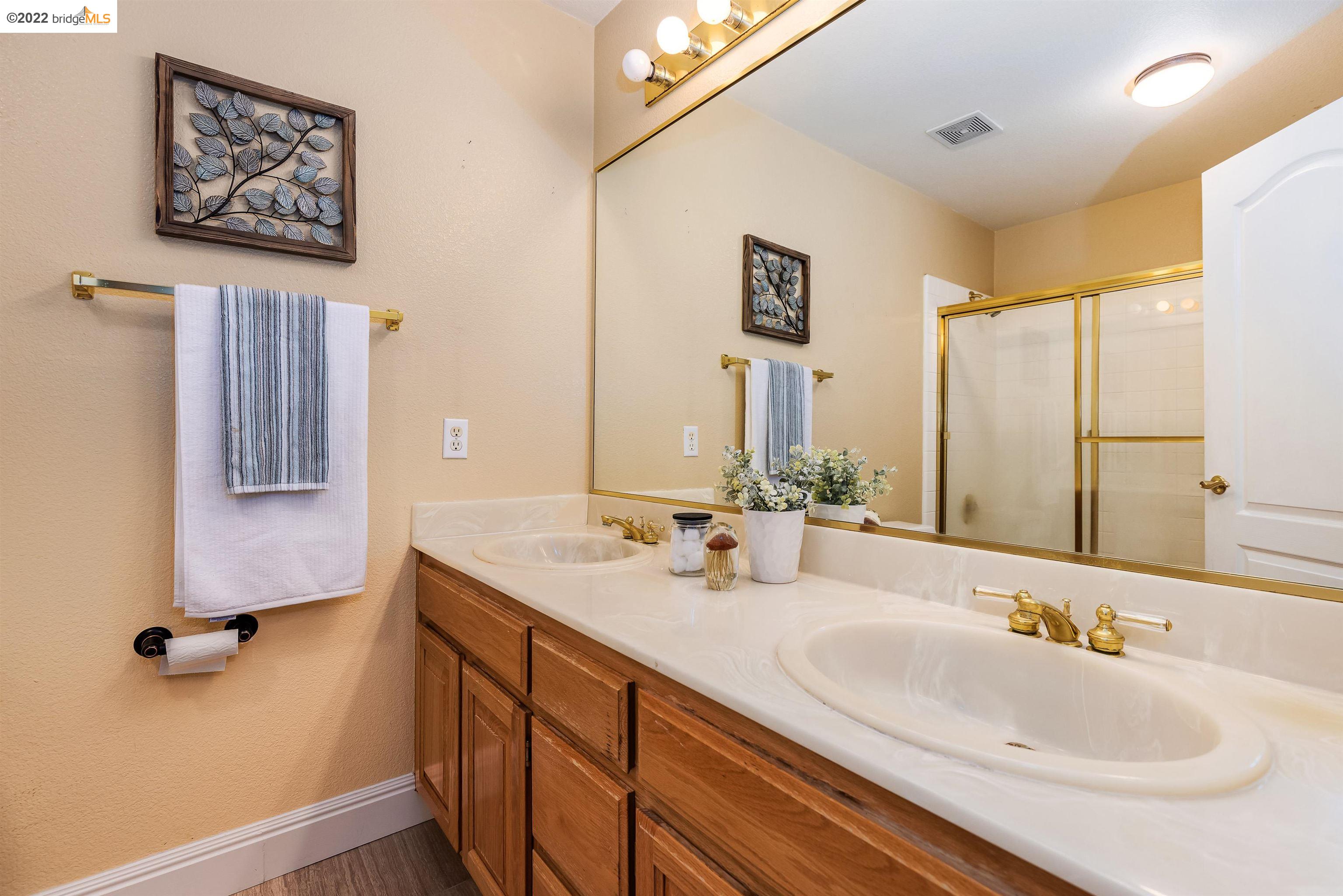 Undisclosed Address Concord, CA 94521 - Photo 29 of 47 a bathroom with a double vanity sink and a mirror