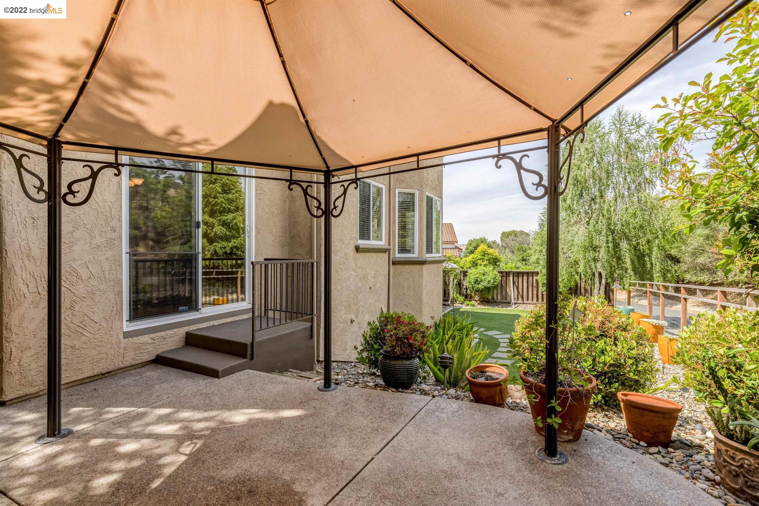 Undisclosed Address Concord, CA 94521 - Photo 36 of 47 a backyard of a house with lots of green space and fountain