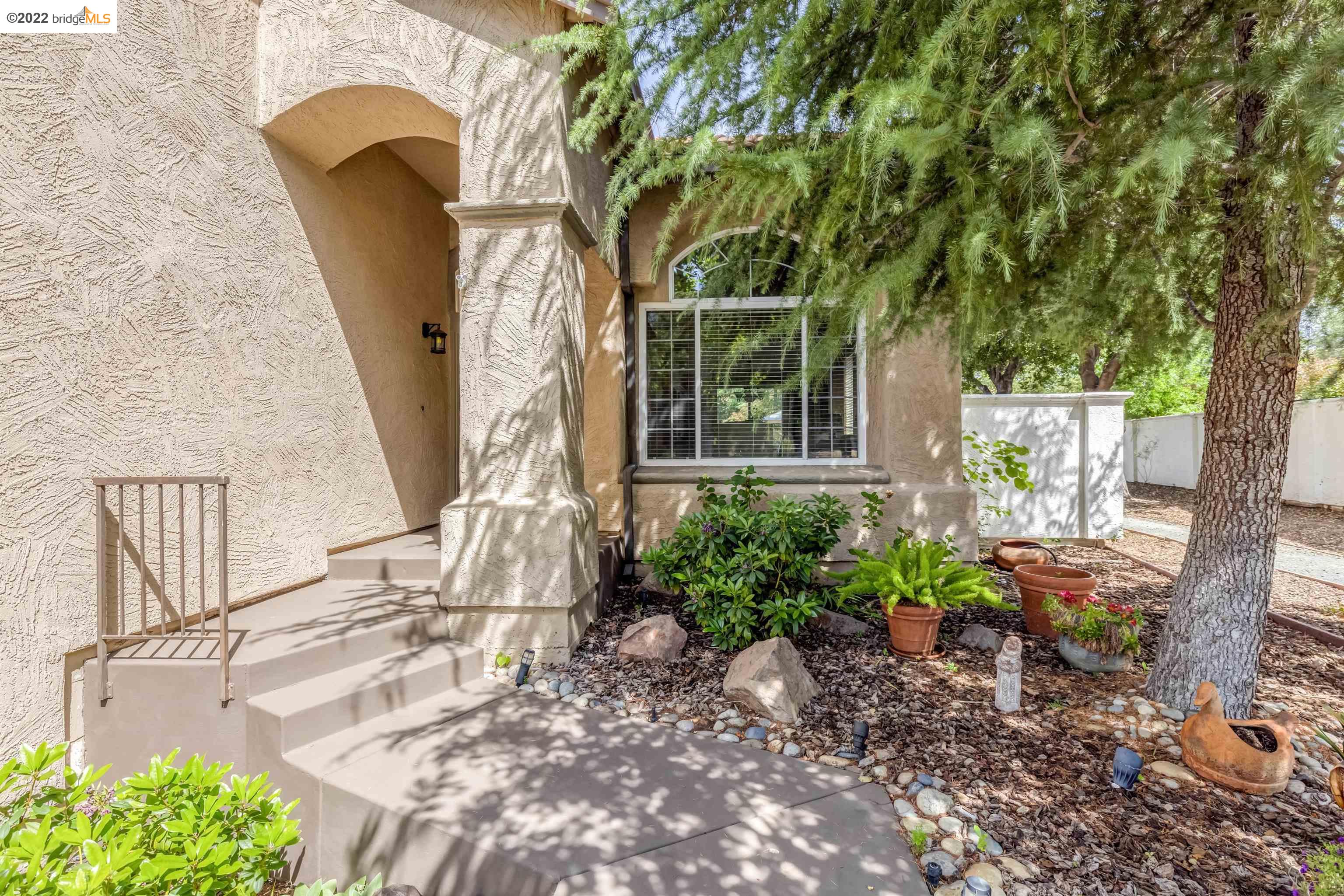Undisclosed Address Concord, CA 94521 - Photo 4 of 47 a front view of a house with garden