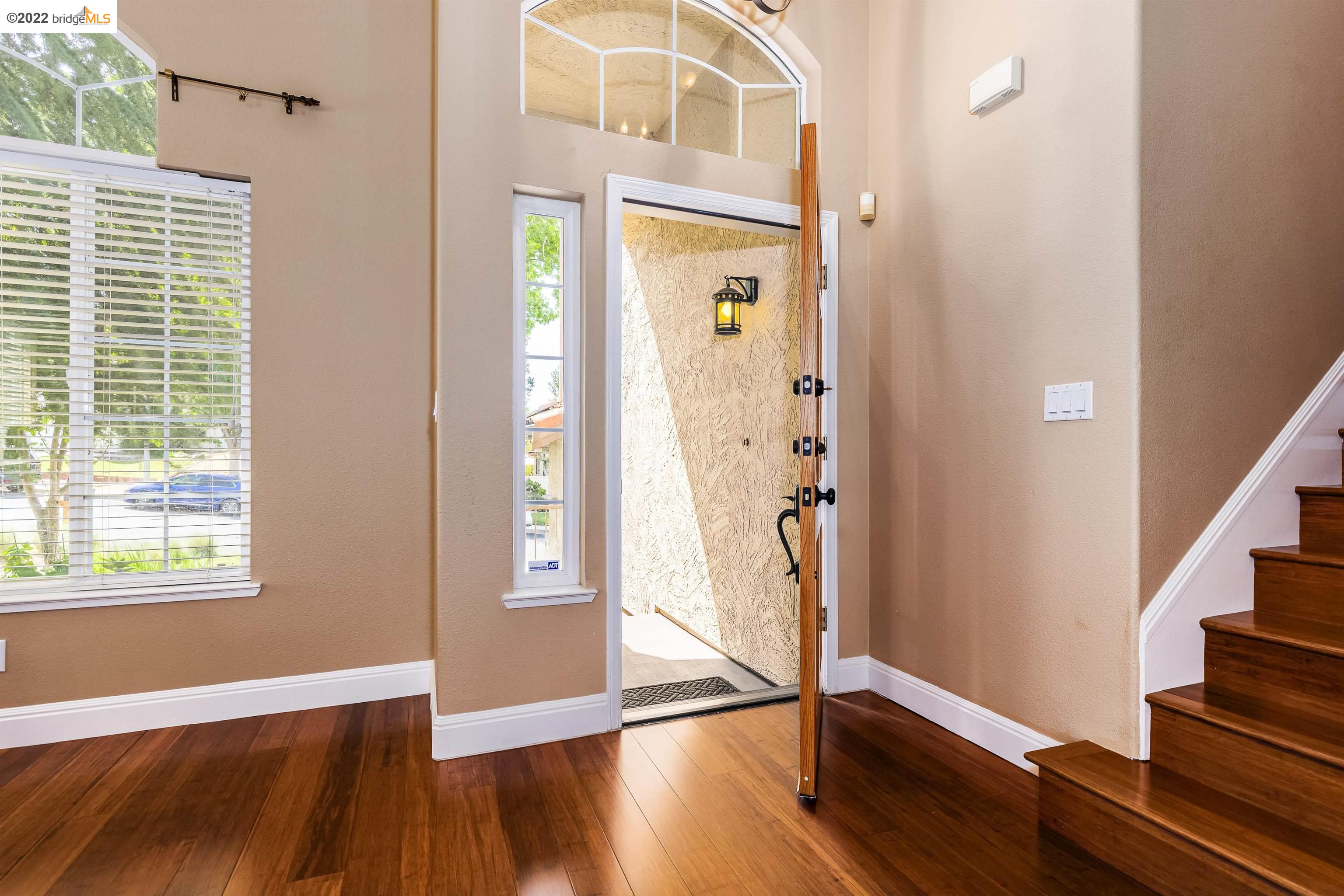 Undisclosed Address Concord, CA 94521 - Photo 5 of 47 a view of an entryway with wooden floor and door