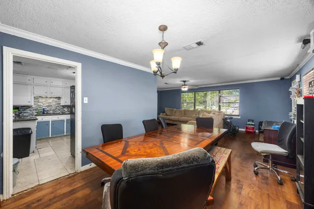 a dining room with a table and a bookshelf