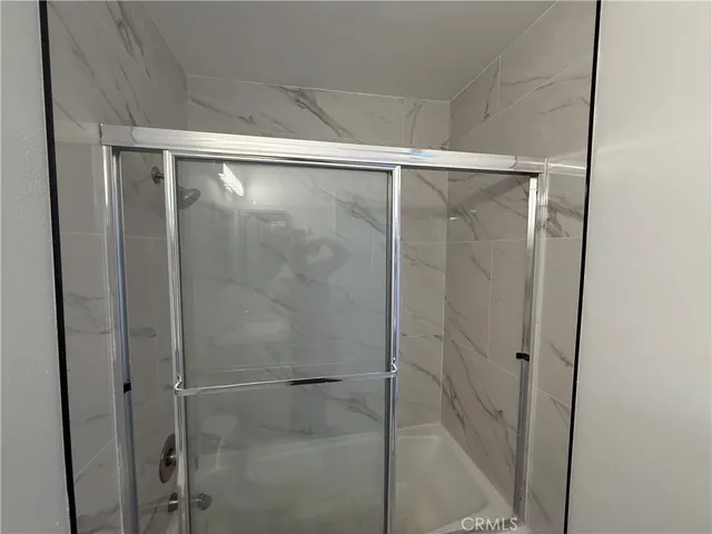 a bathroom with a glass shower door