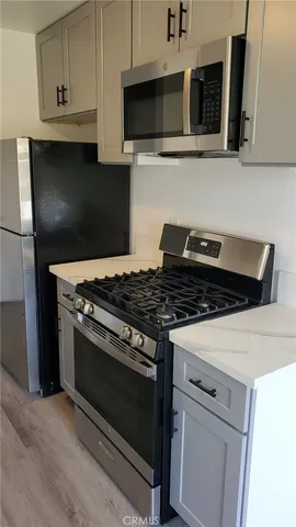 a stove top oven sitting inside of a kitchen
